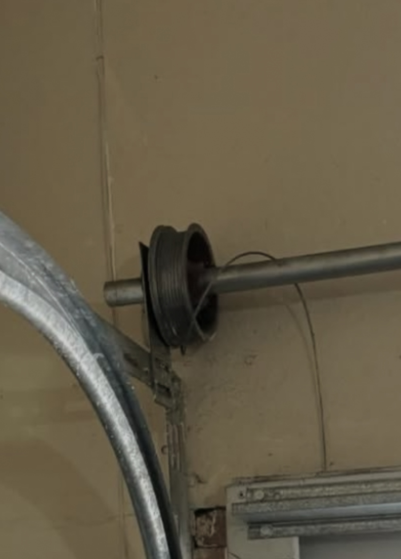 Snapped garage door cable hanging loose